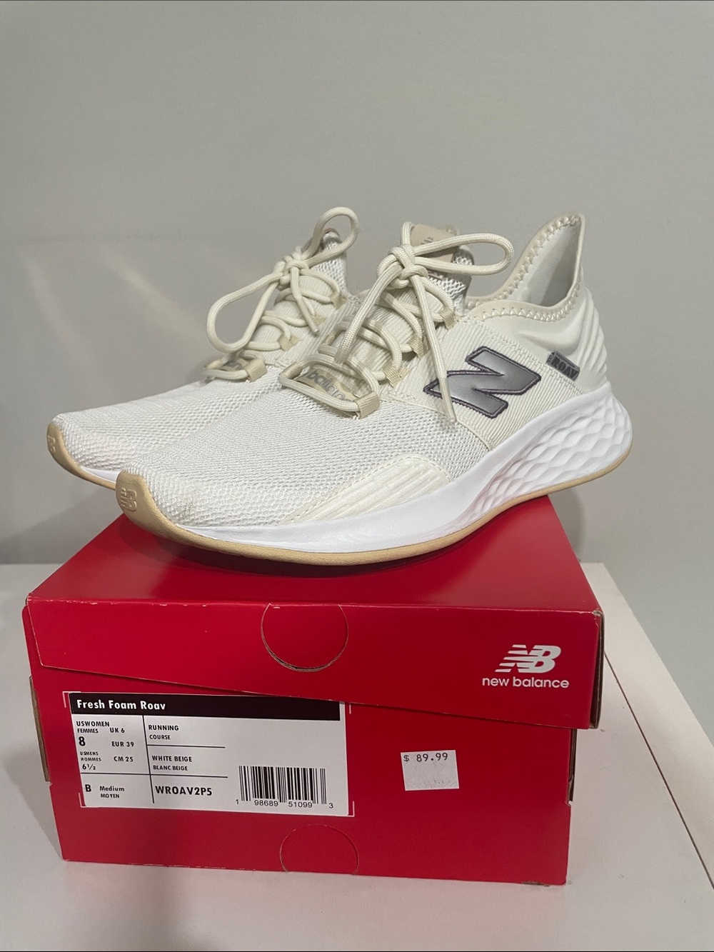 New Balance women's athletic sneakers in white and beige